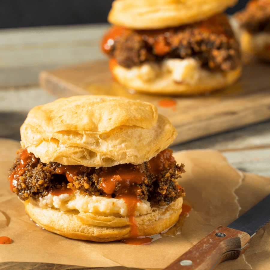 Two Hot Honey Chicken Sandwiches sitting on cutting boards