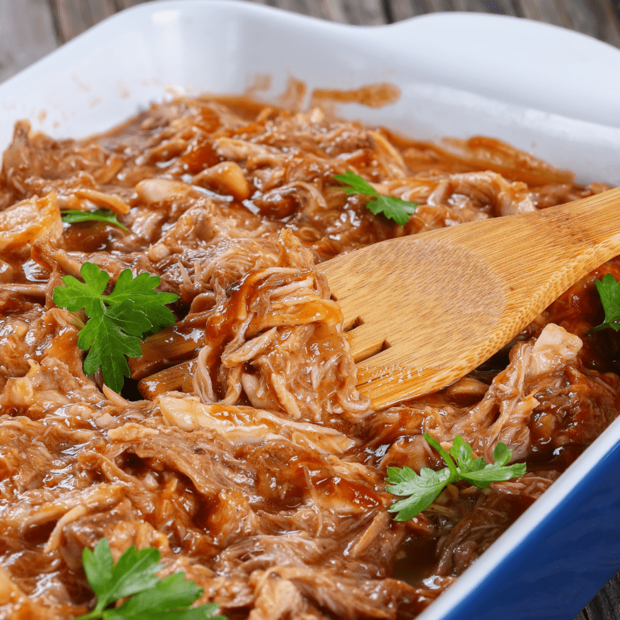 Instant Pot BBQ Chicken with a wooden serving spoon in it