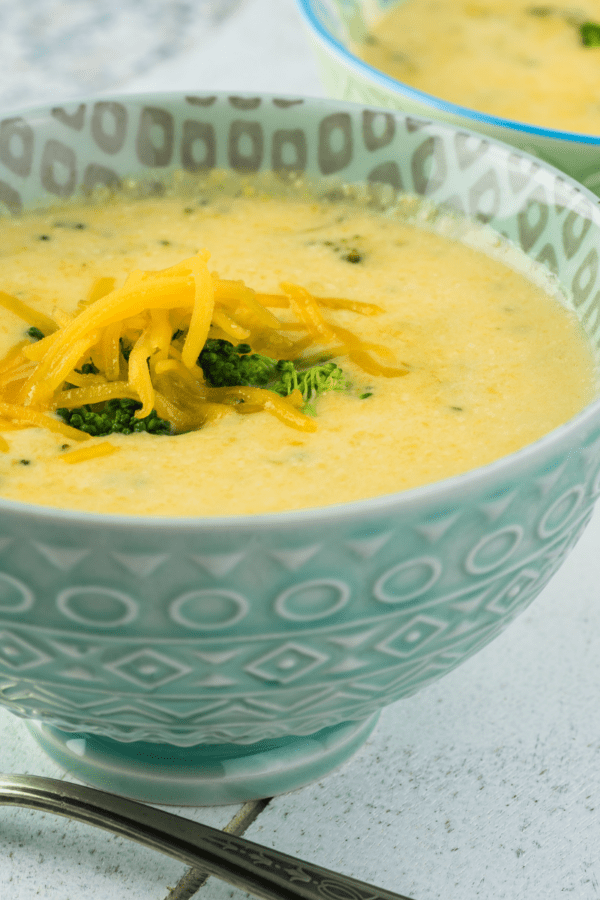 Instant Pot Broccoli Cheddar Soup in a light blue bowl