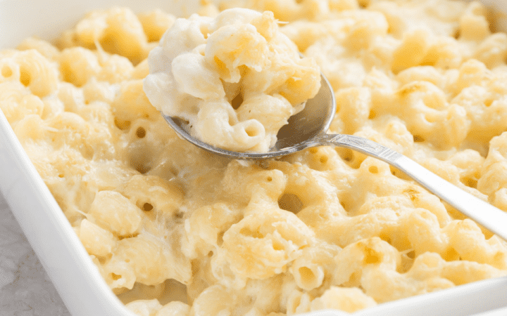 panera mac and cheese recipe copycat in a white baking dish with a serving spoon