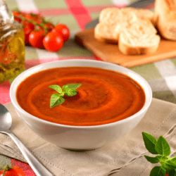 Pomodoro sauce in a white bowl with a garnish of fresh herbs