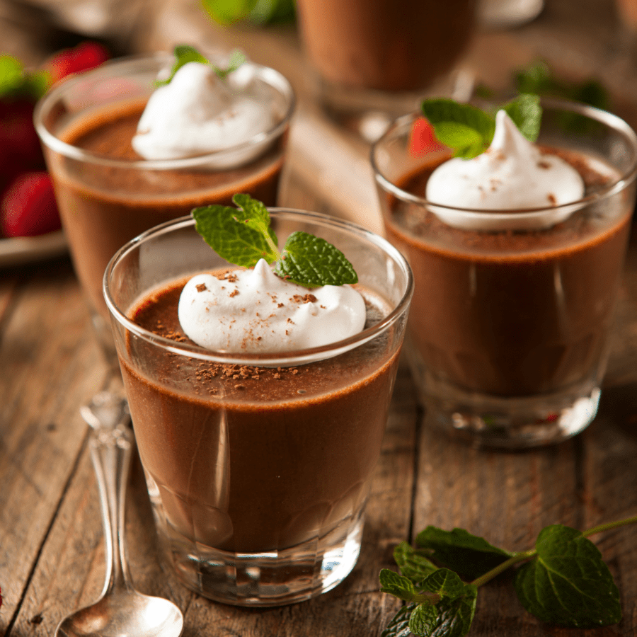 Three glasses with protein pudding on a wooden table