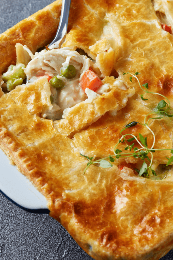 Chicken Pot Pie Casserole with a spoon taking a scoop out of it