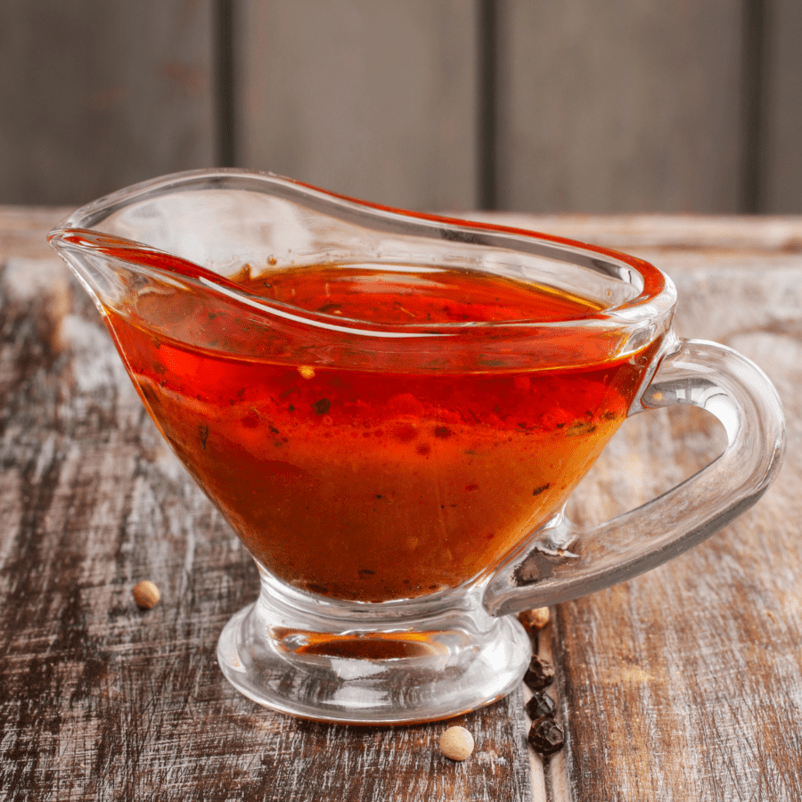 Chicken Thigh Marinade in a glass serving jar on a wooden table