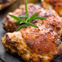 Grilled chicken thighs with an herb garnish