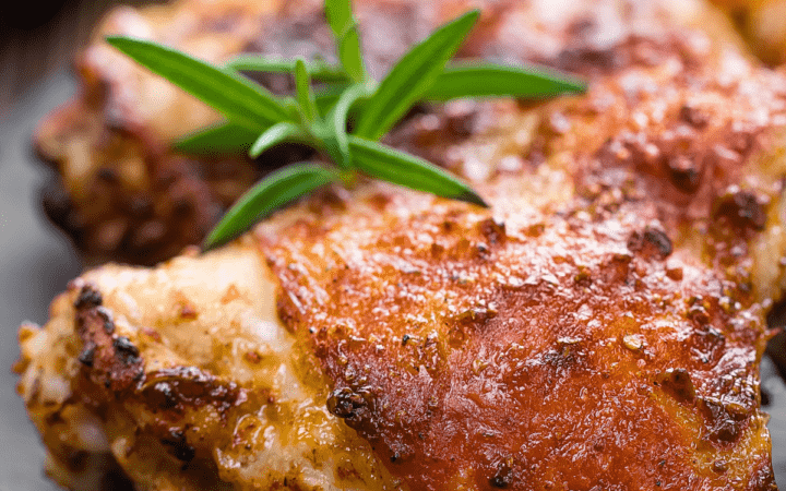 Grilled chicken thighs with an herb garnish