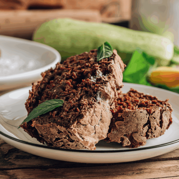 Chocolate zucchini cake on a white plate