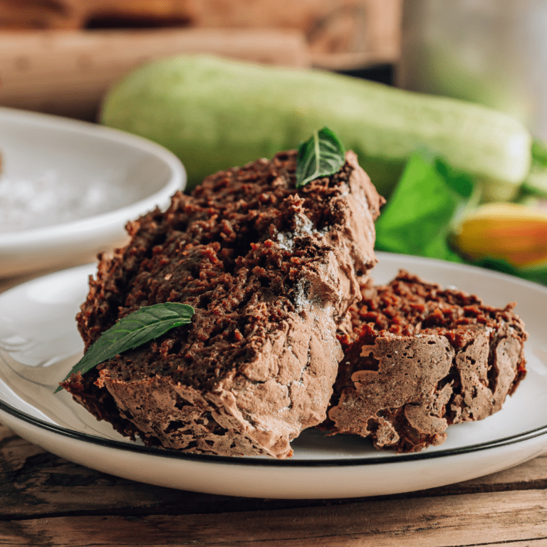 Chocolate zucchini cake on a white plate