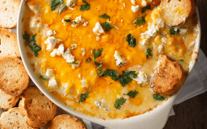 Buffalo Chicken Crock Pot Dip in a round pan served with baguettes