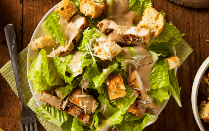 Overhead image of Chicken Caesar Salad on a wooden table