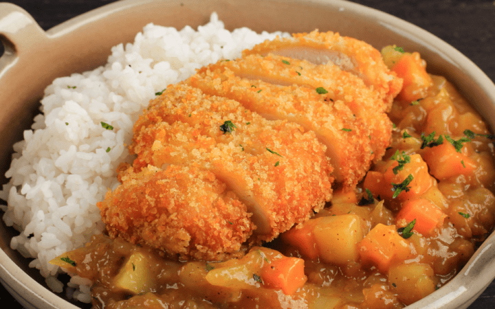 Chicken Katsu Curry served in a pan with rice