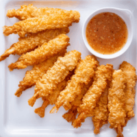 Tempura Shrimp on a white plate with dipping sauce
