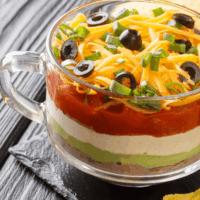 close up image of a taco dip recipe in a glass mug