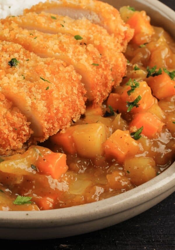 Closup shot of Chicken Katsu Curry in a beige pan