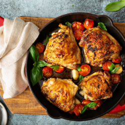 Pollo Asado in a skillet on a cutting board