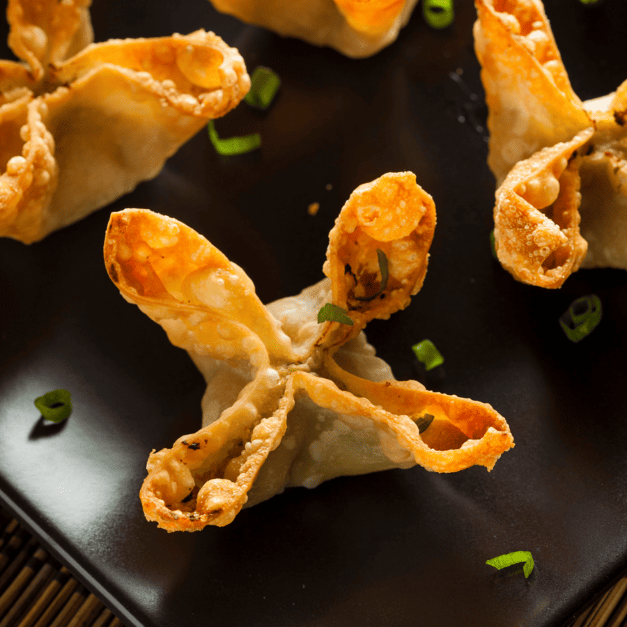 Close up of air fryer crab rangoon on a black plate