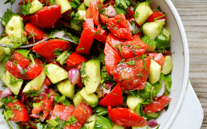 Cucumber Tomato Onion Salad in a white serving dish