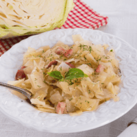 Southern Fried Cabbage with bacon on a white decorative plate