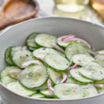 Creamy Cucumber salad in a white bowl