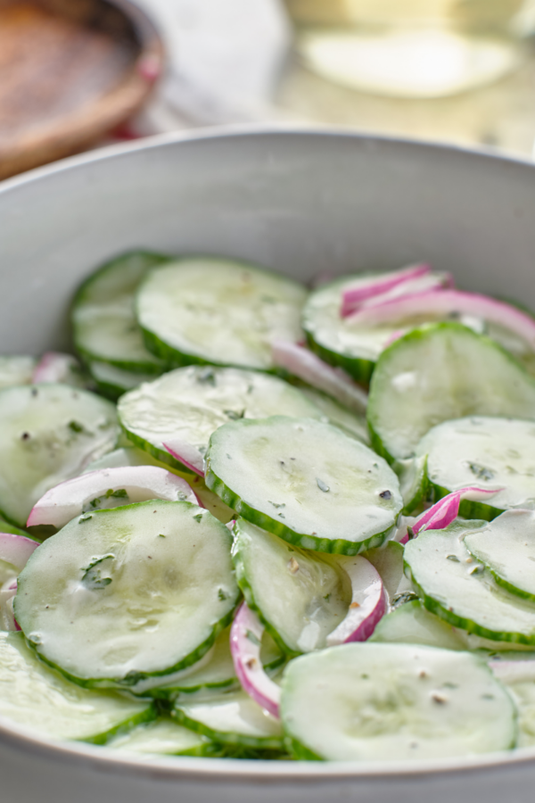 Creamy Cucumber salad in a white bowl