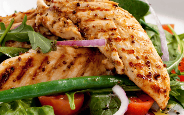 Grilled Chicken Tenders on a bed of greens and vegetables