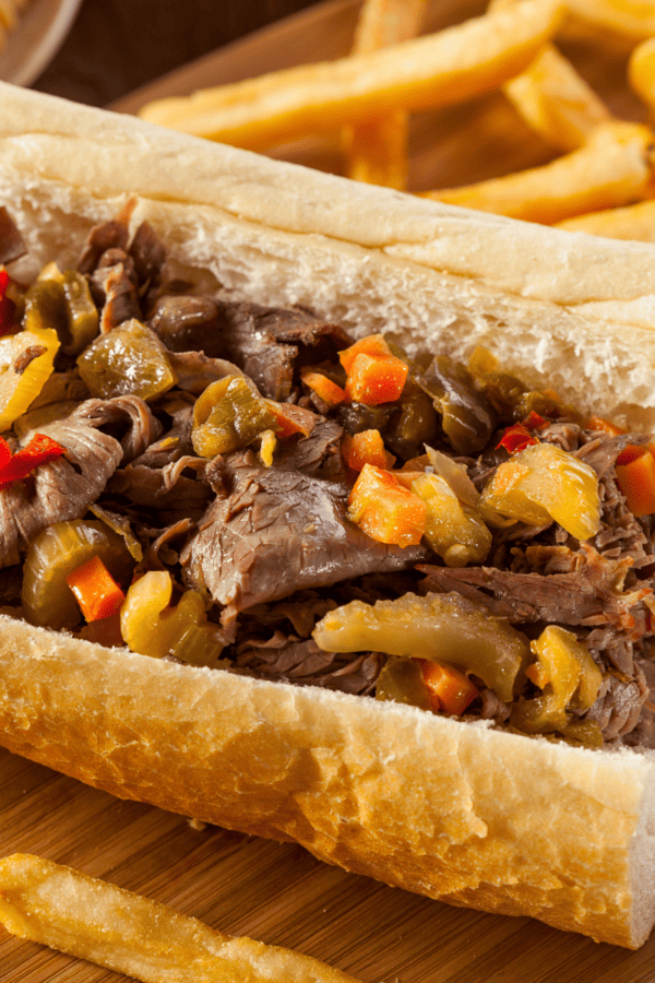 Italian Beef Sandwich on a roll with a side of french fries