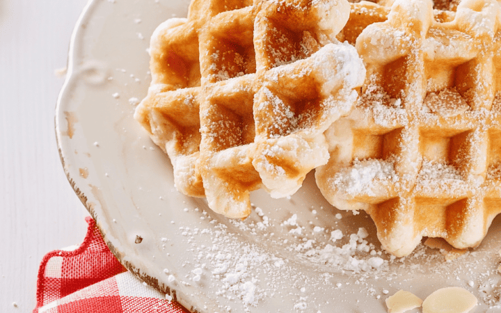 Closeup of Protein Waffles on a white plate and red and white checked napkin
