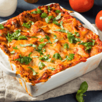 Vegetable lasagna in a white casserole dish