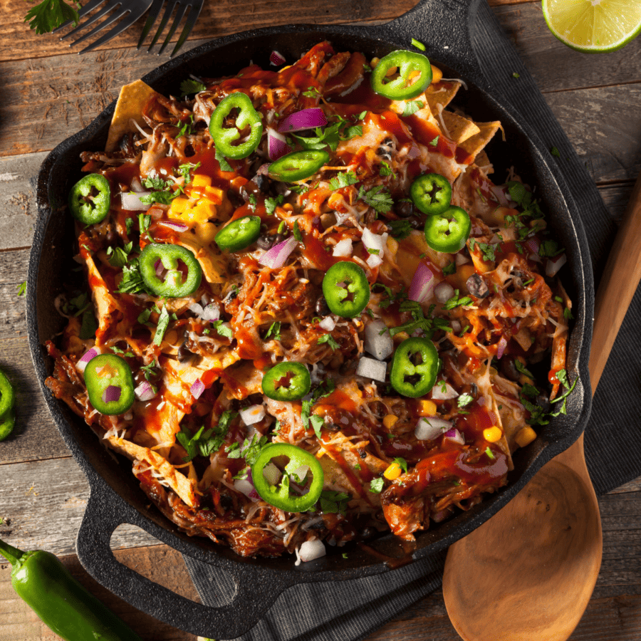 Overhead image of chicken nachos in a cast iron pan