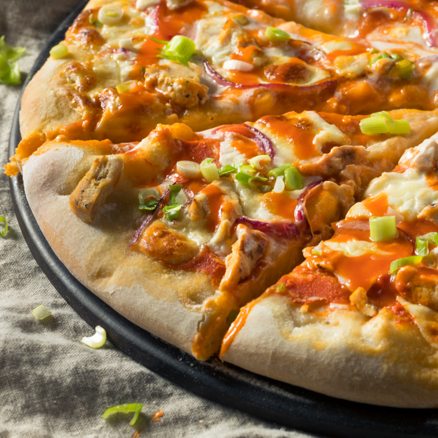 Close up image of buffalo chicken pizza on a pizza pan