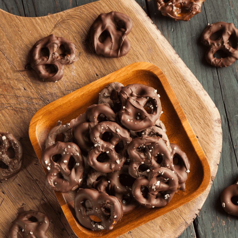 Overhead image of Chocolate Covered Pretzels in a serving bowl and scattered