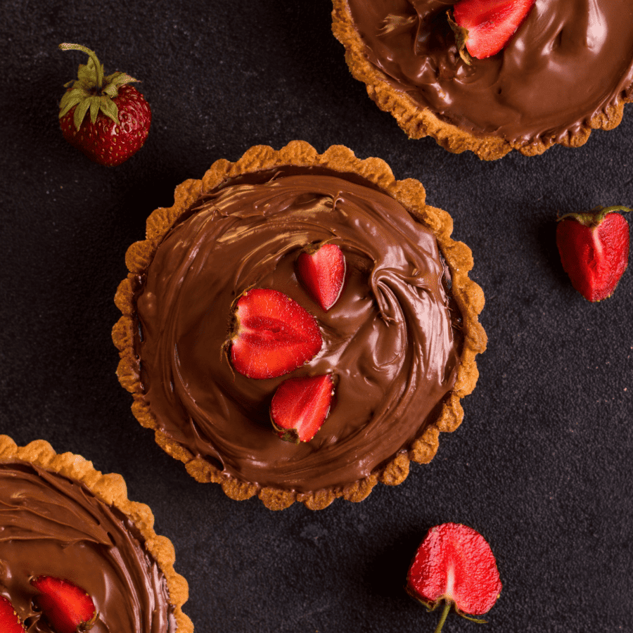 three low carb chocolate pudding pies with strawberry garnish