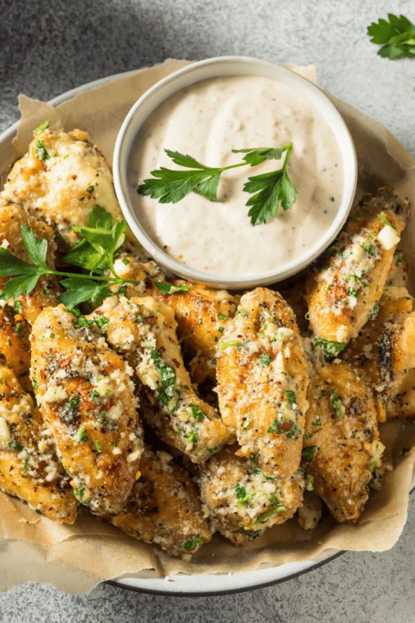 Overhead image of garlic parmesan wings with dipping sauce