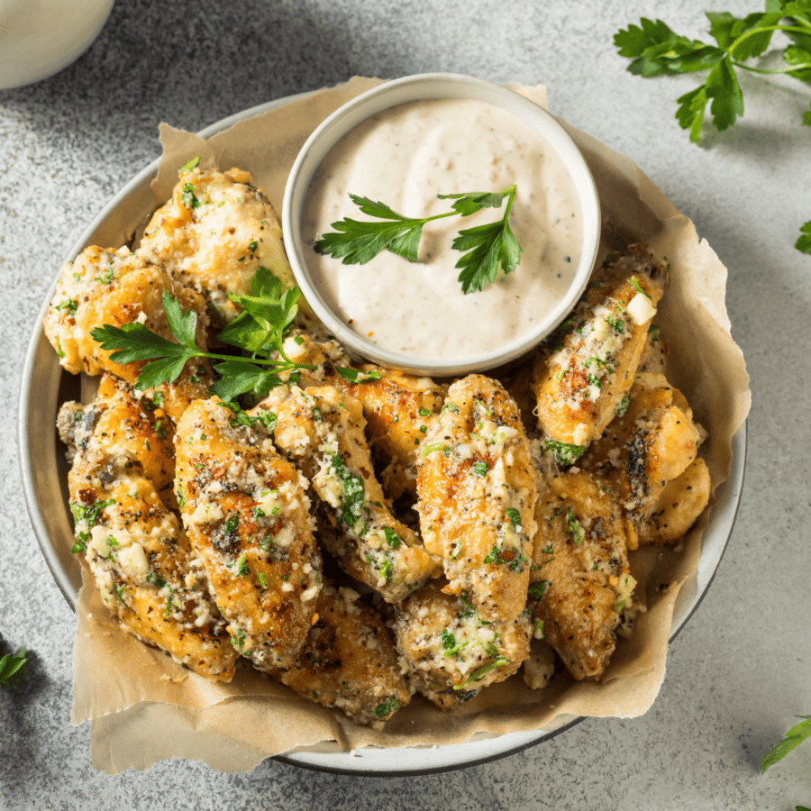 Overhead image of garlic parmesan wings with dipping sauce