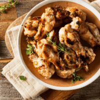 Overhead image of lemon pepper wings on a brown plate