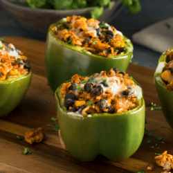Mexican Stuffed Peppers on a wooden cutting board