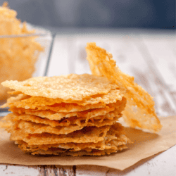Parmesan Crisps stacked on parchment paper