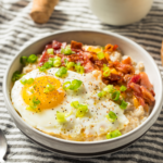 Overhead image of savory oatmeal with bacon and eggs