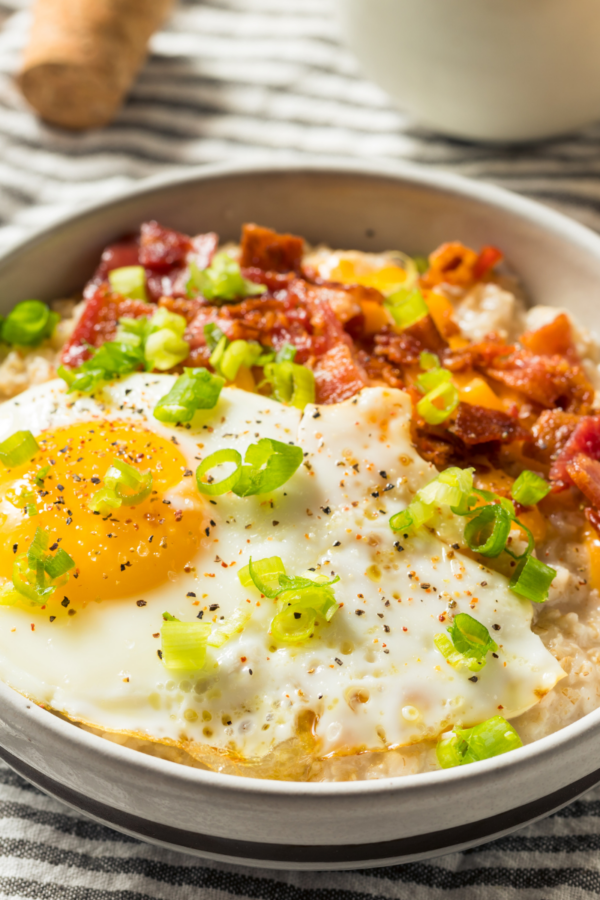 Overhead image of savory oatmeal with bacon and eggs