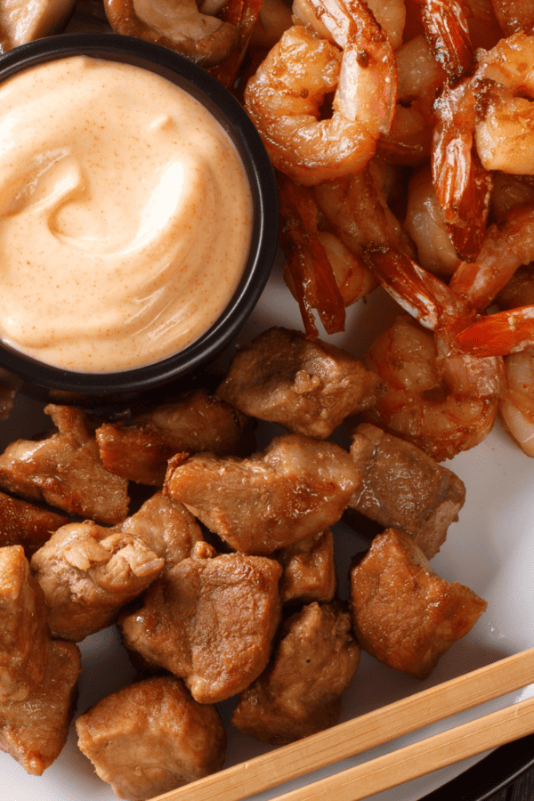 Low Carb Hibachi Sauce in a ramekin with steak and shrimp