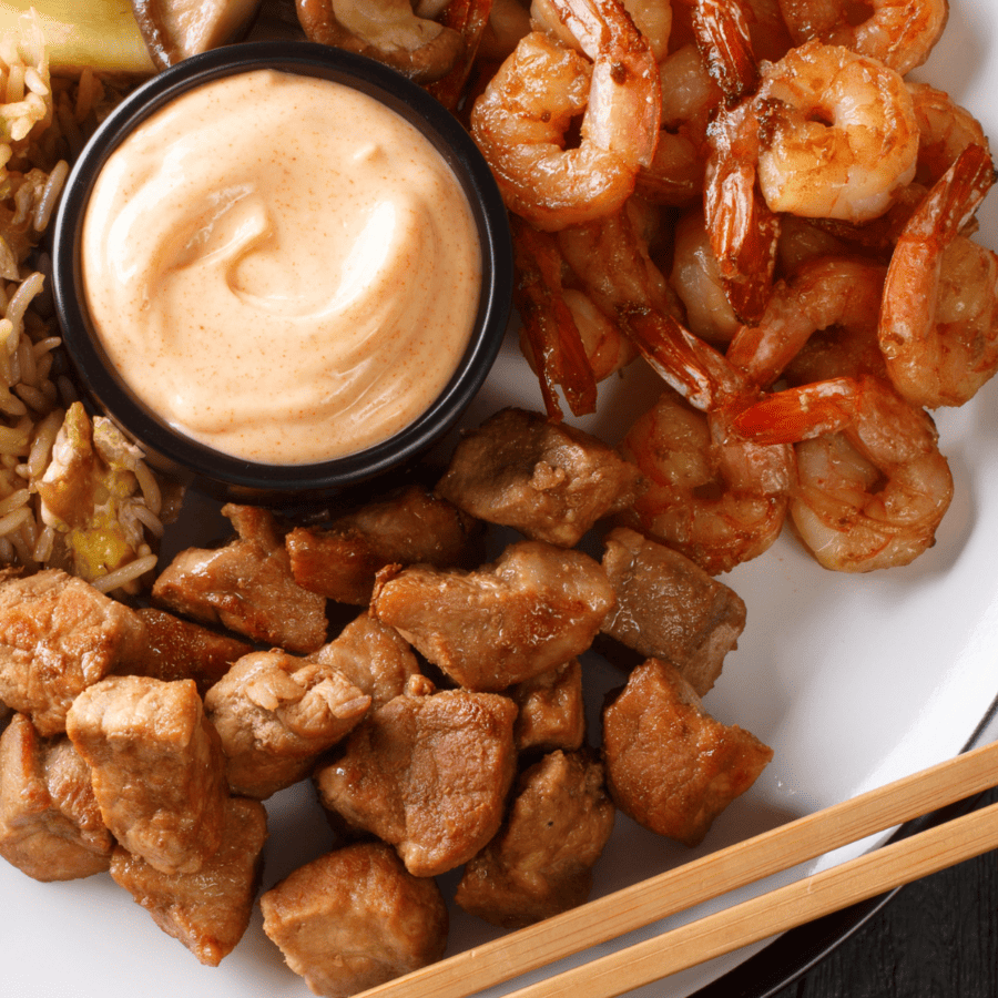 Low Carb Hibachi Sauce in a ramekin with steak and shrimp