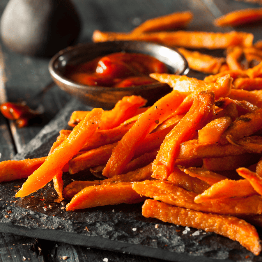 Close up image of sweet potato fries with a side of ketchup