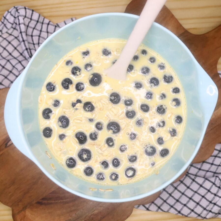 Baked Oatmeal batter in a bowl with a silicone spatula