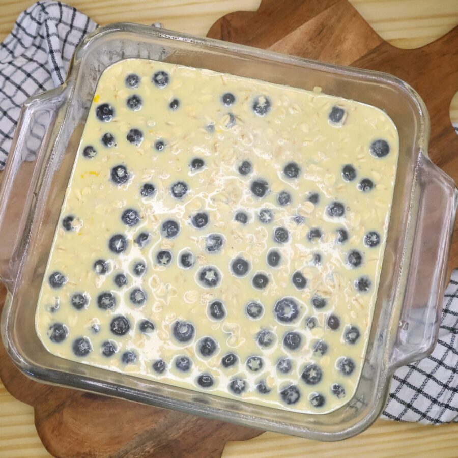 Unbaked blueberry oatmeal batter in a 8x8 glass dish