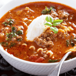 Lasagna Soup in a white bowl with a spoon in it