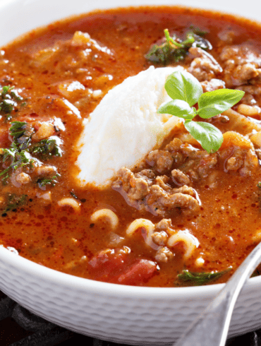 Lasagna Soup in a white bowl with a spoon in it