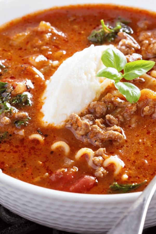 Lasagna Soup in a white bowl with a spoon in it