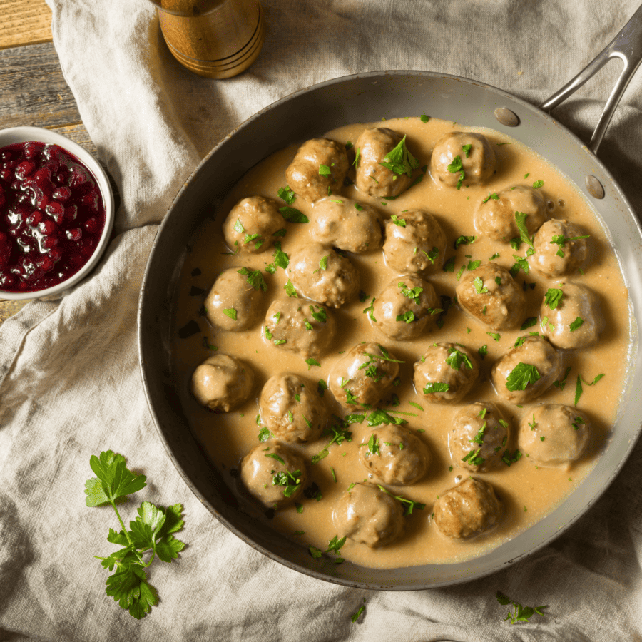 instant pot swedish meatballs in a pan with a side of lingonberry jam