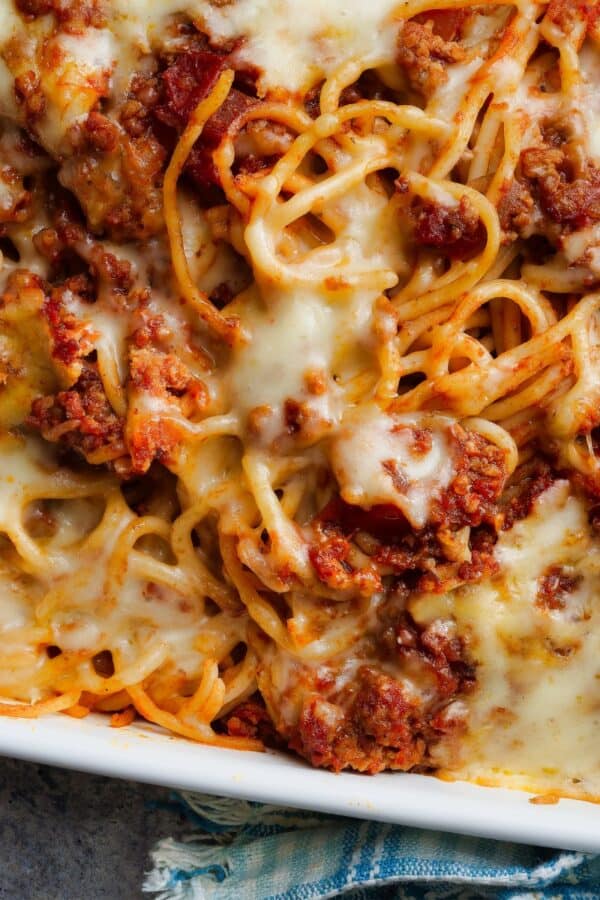 Close up image of baked spaghetti in a baking dish
