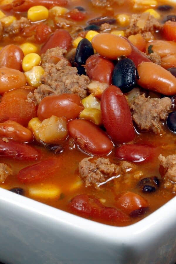 Close up image of Crockpot Taco Soup in a square white bowl